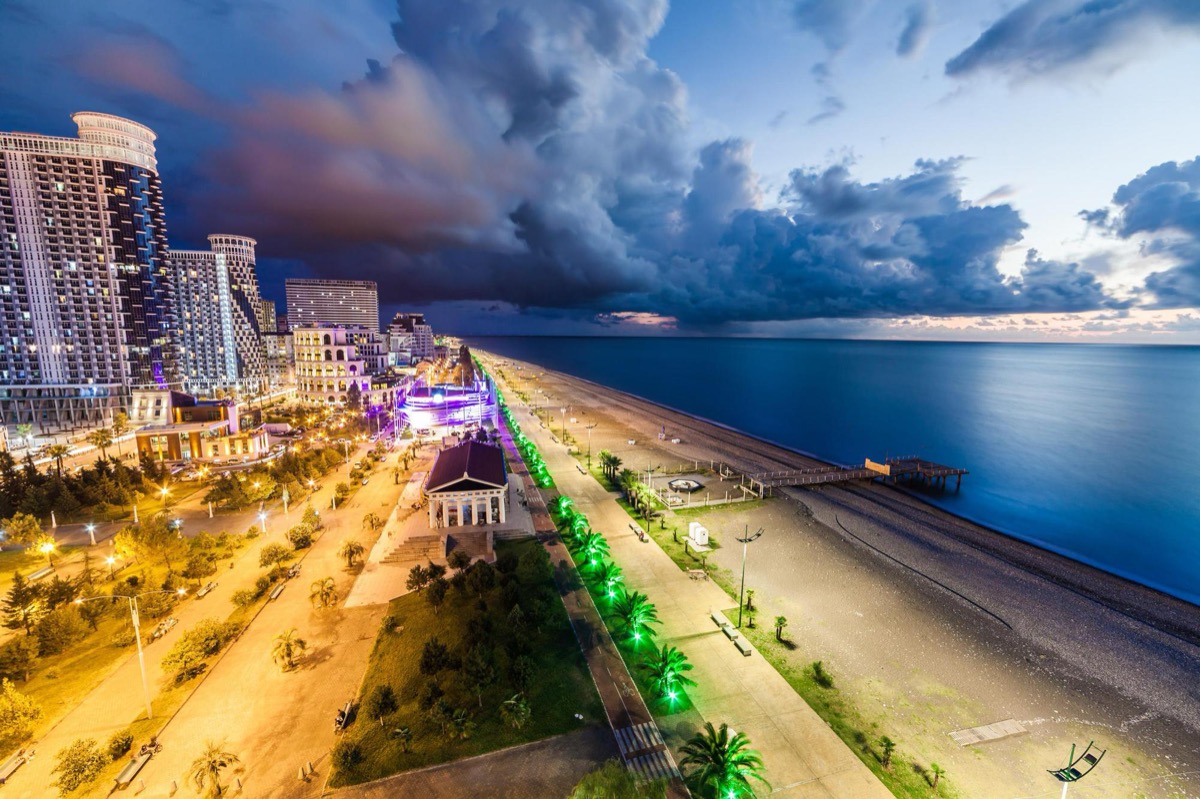 Black Sea beach in Batumi with palm trees and blue water
