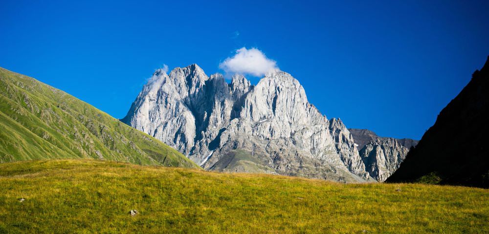 Chaukhi rock formations rising dramatically against the sky