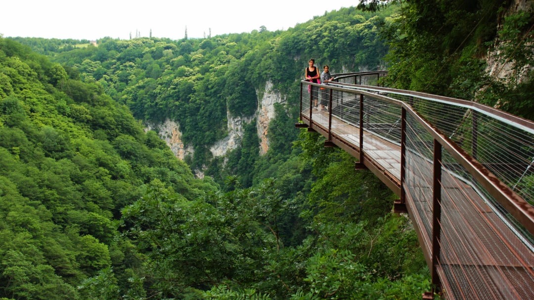 Boat gliding through narrow Martvili Canyon walls