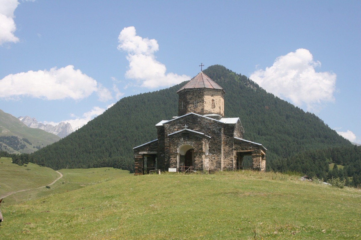 Traditional Tushetian shepherd with flock